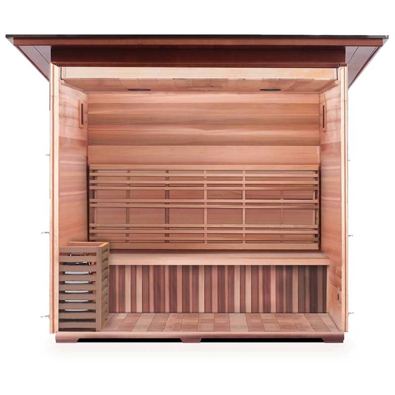 Cedar outdoor sauna with spacious wooden bench and modern heater.
