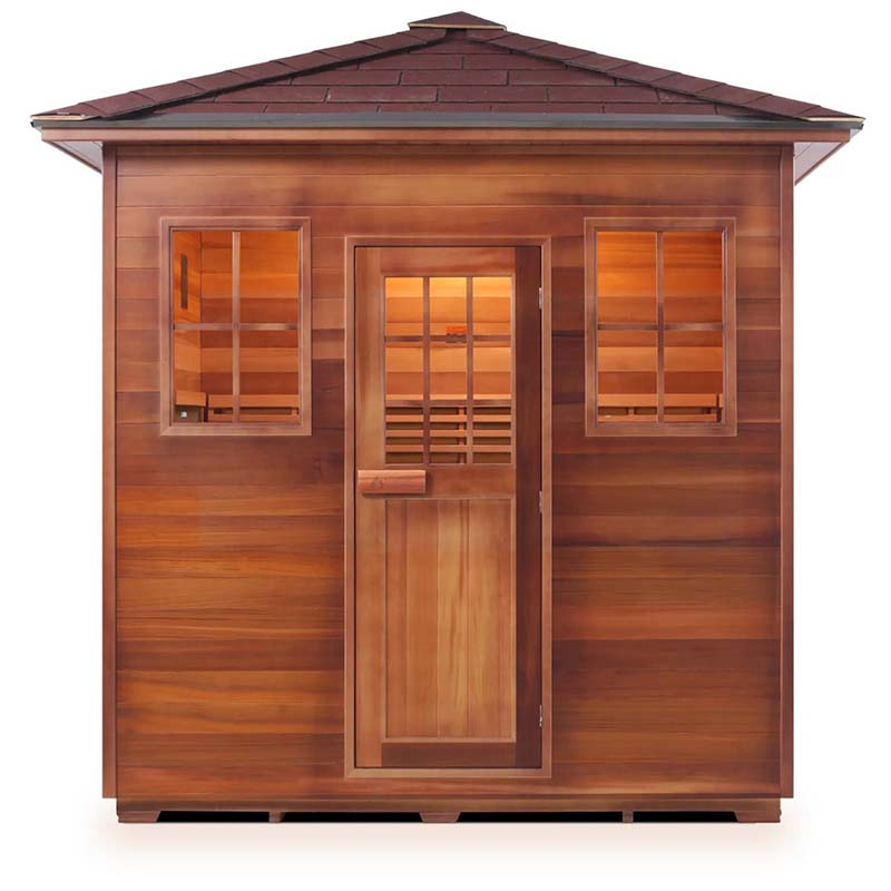 Cedar barrel sauna with windows and a shingled roof, ideal for outdoor relaxation.