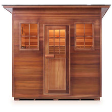 Outdoor cedar sauna with glass door and window panels featuring warm interior lighting.
