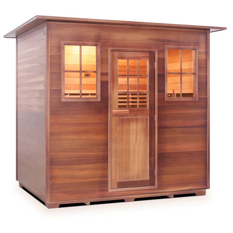 Wooden outdoor sauna with windows and door, showcasing warm interior lighting.