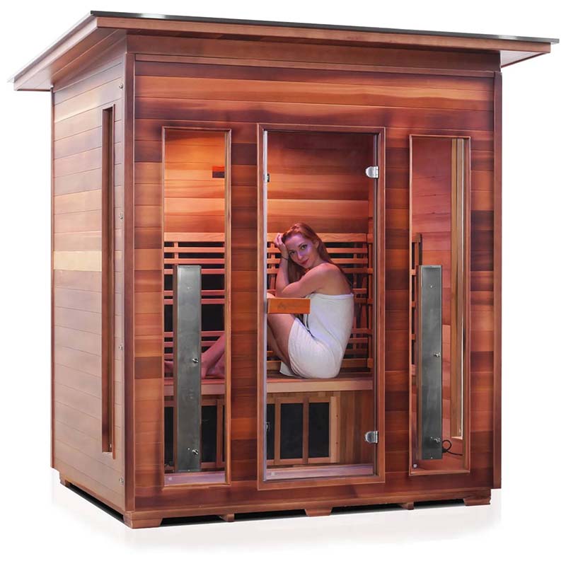 Cedar infrared sauna with glass door and woman inside, highlighting relaxation benefits.