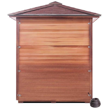 Wooden outdoor sauna with shingle roof and coiled hose at the base.