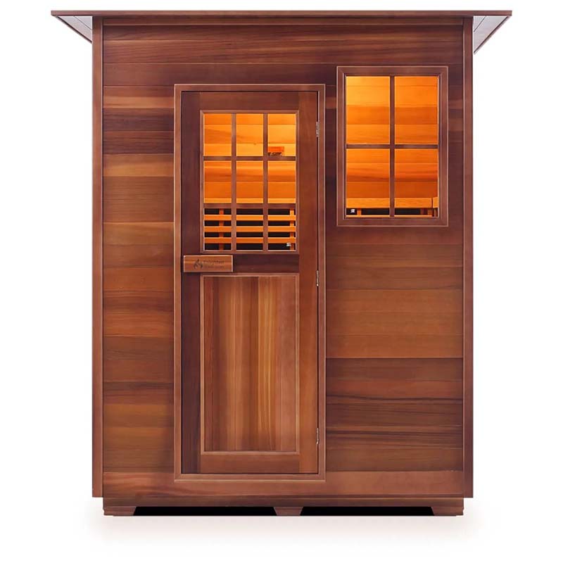 Outdoor cedar sauna with glass door and window, warm interior glow.