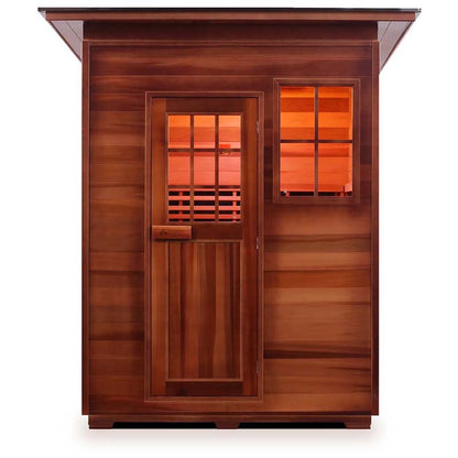 Cedar infrared sauna cabin with window, showcasing warm interior lighting.