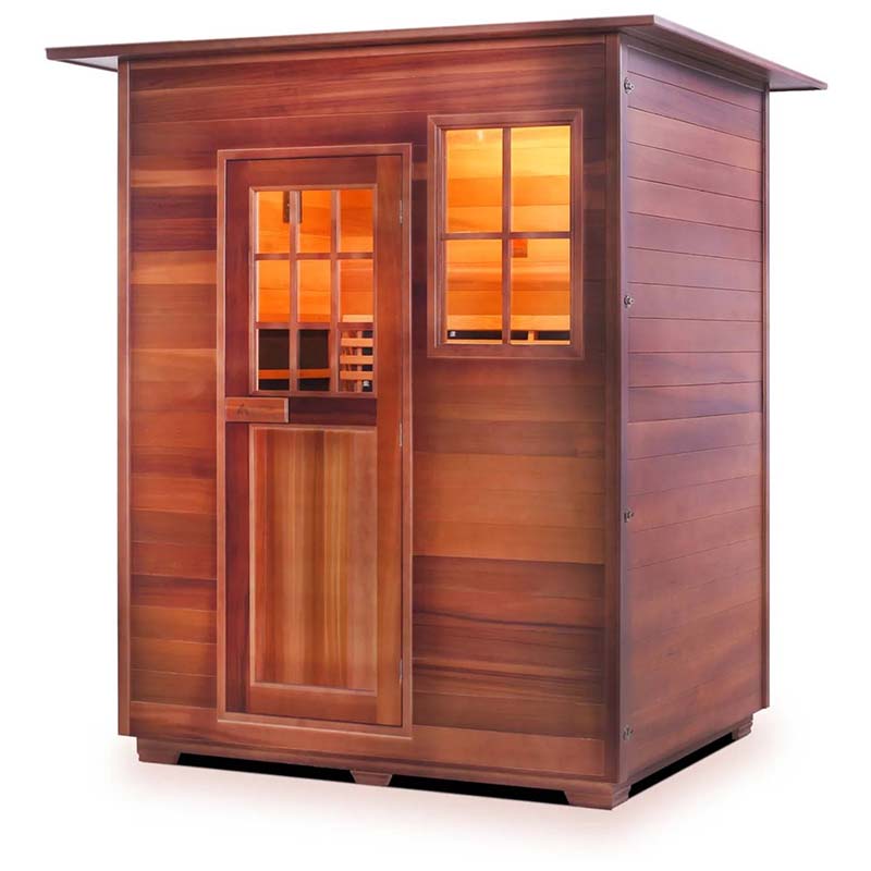 Cedar outdoor sauna with glass door and window, featuring warm interior lighting.