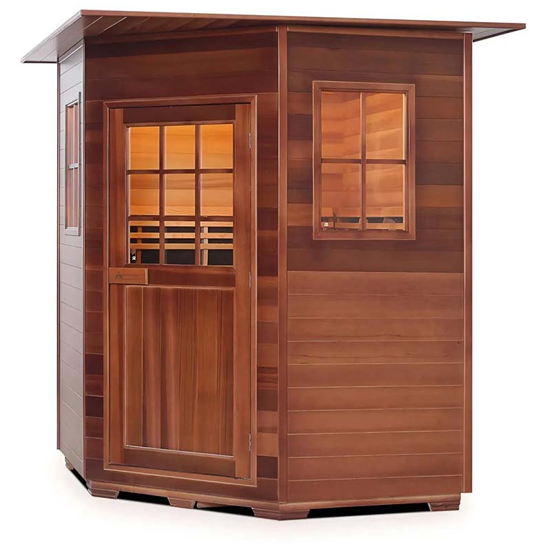 Wooden outdoor sauna with glass windows and door, featuring warm interior lighting.