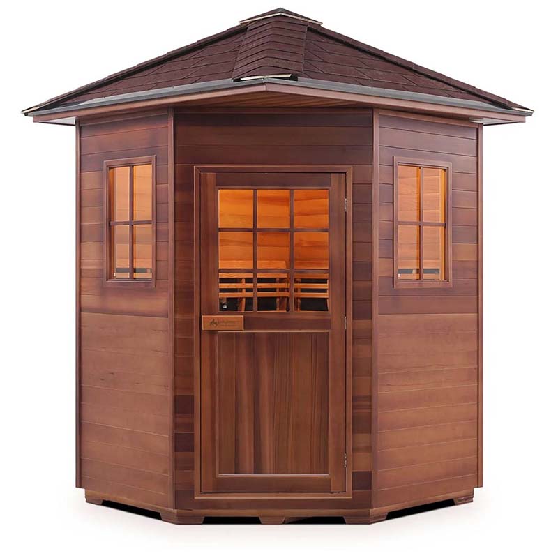 Outdoor cedar sauna with shingled roof and windowed door for relaxation.