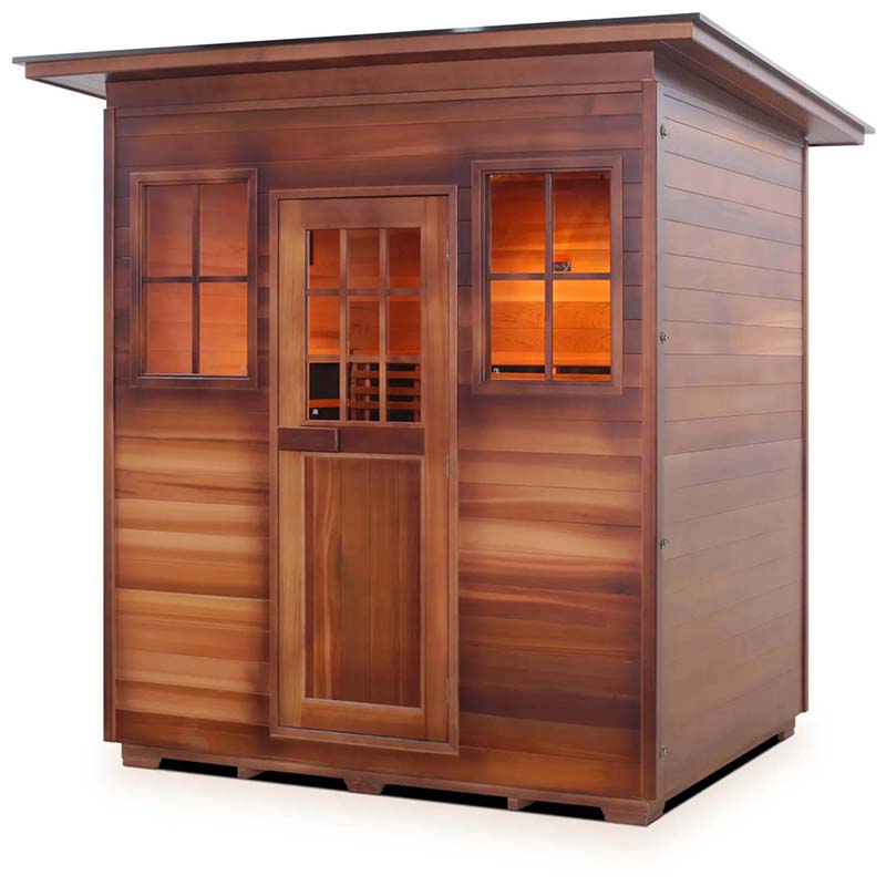 Outdoor cedar sauna with windows and a slanted roof, ideal for home relaxation.