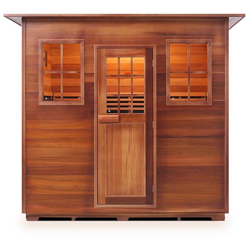 Cedar infrared sauna cabin with glass windows and door, warm interior lighting.