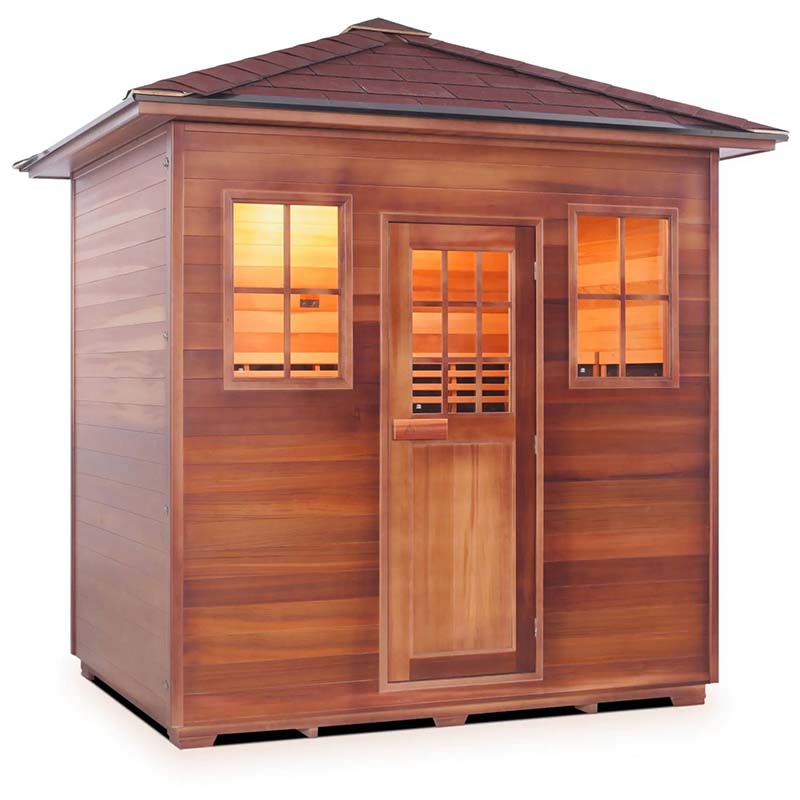 Wooden outdoor sauna cabin with warm interior lighting and shingled roof.