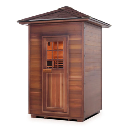 A wooden outdoor sauna with a sloped roof and a glass-paneled door, showcasing natural cedar wood siding.