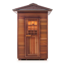 A wooden sauna with a peaked roof and a glass-paneled door, showcasing a warm, inviting interior.