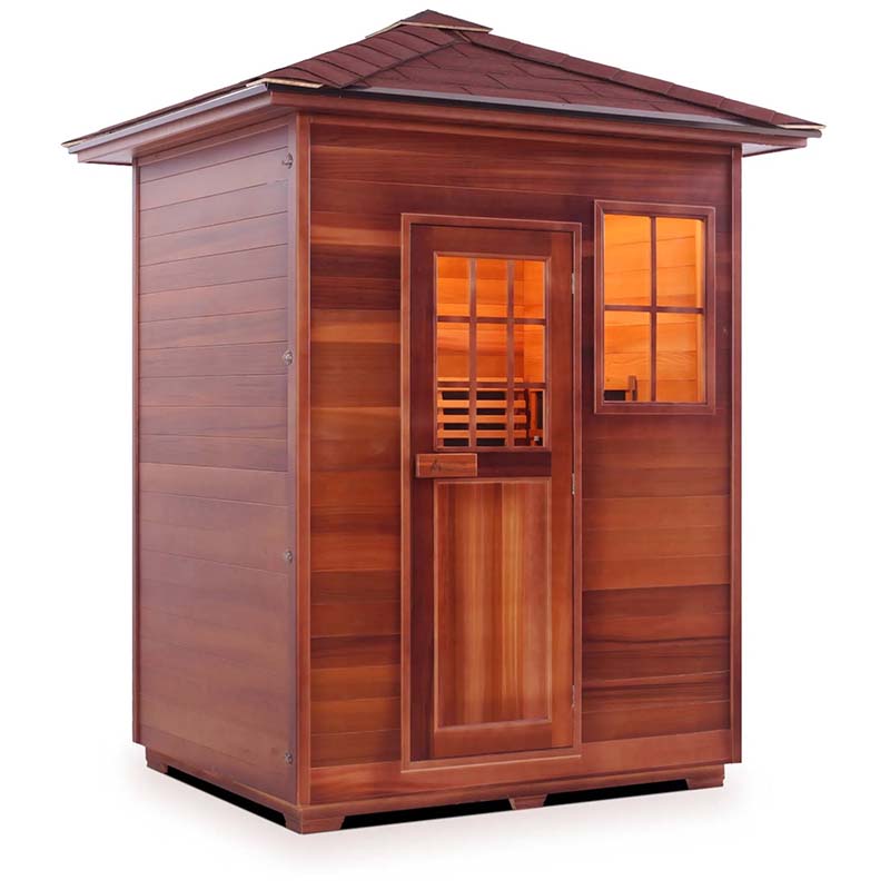Outdoor cedar sauna with glass windows and door, featuring a sloped roof design.