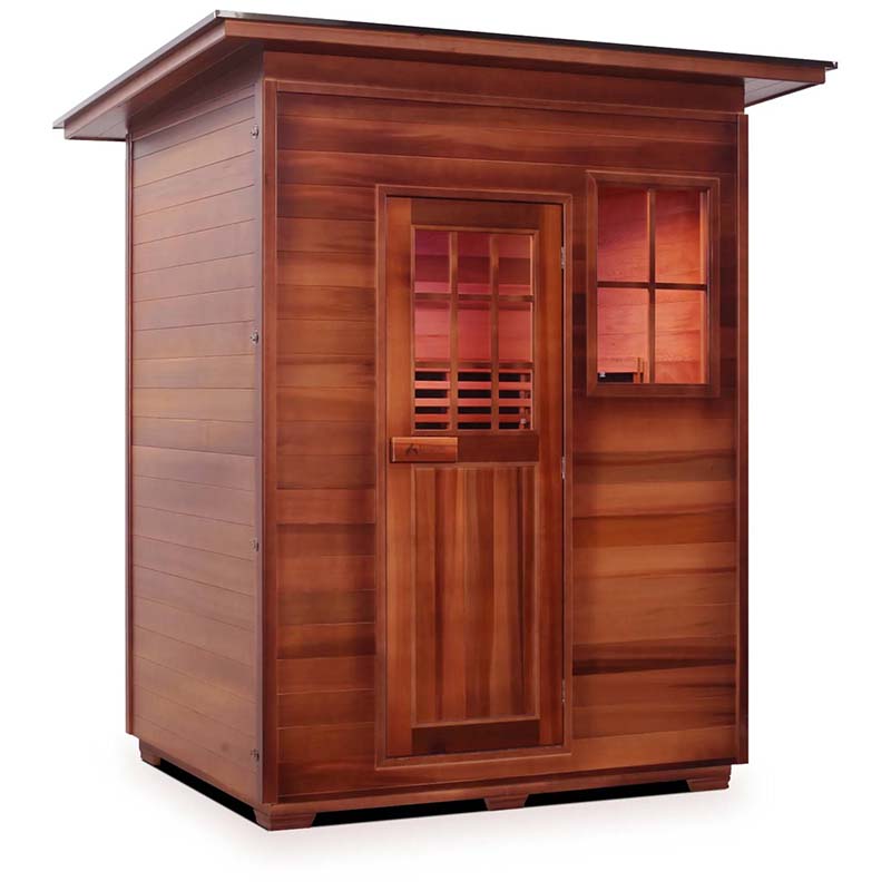 Outdoor cedar sauna with window and slatted door, ideal for relaxation and wellness.