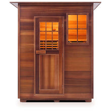Cedar infrared sauna with glass door and window, warm interior glow.