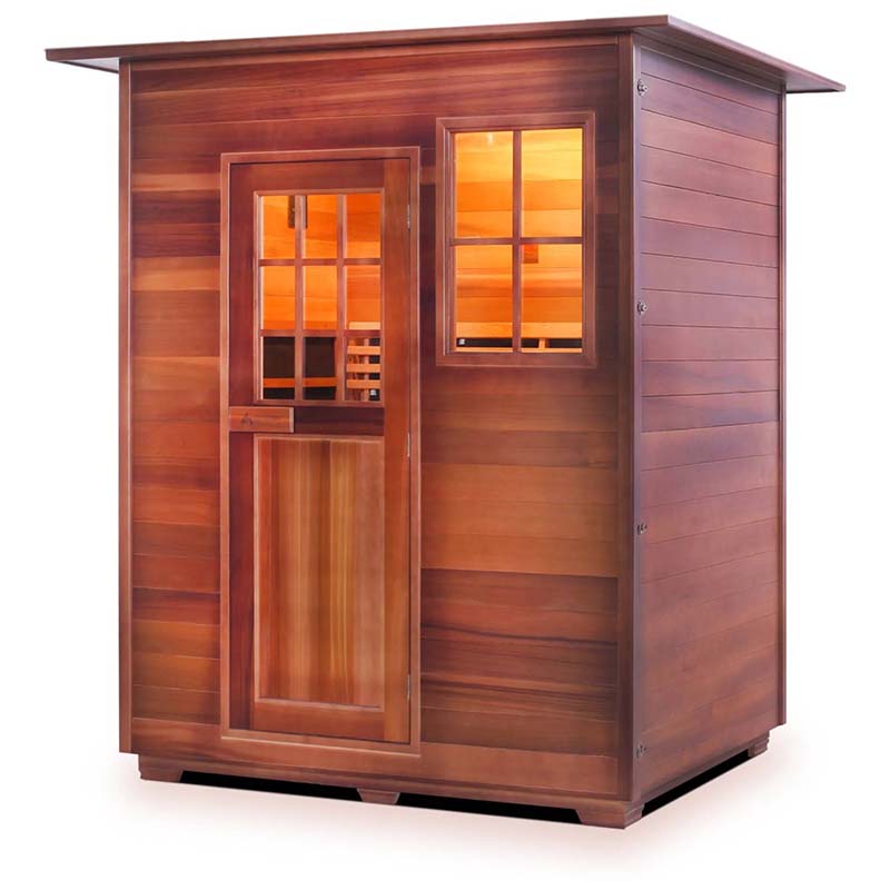 Cedar sauna with glass door and window, featuring warm interior lighting.