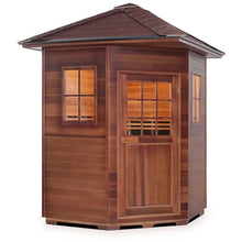 Wooden outdoor sauna with windows and a shingled roof.