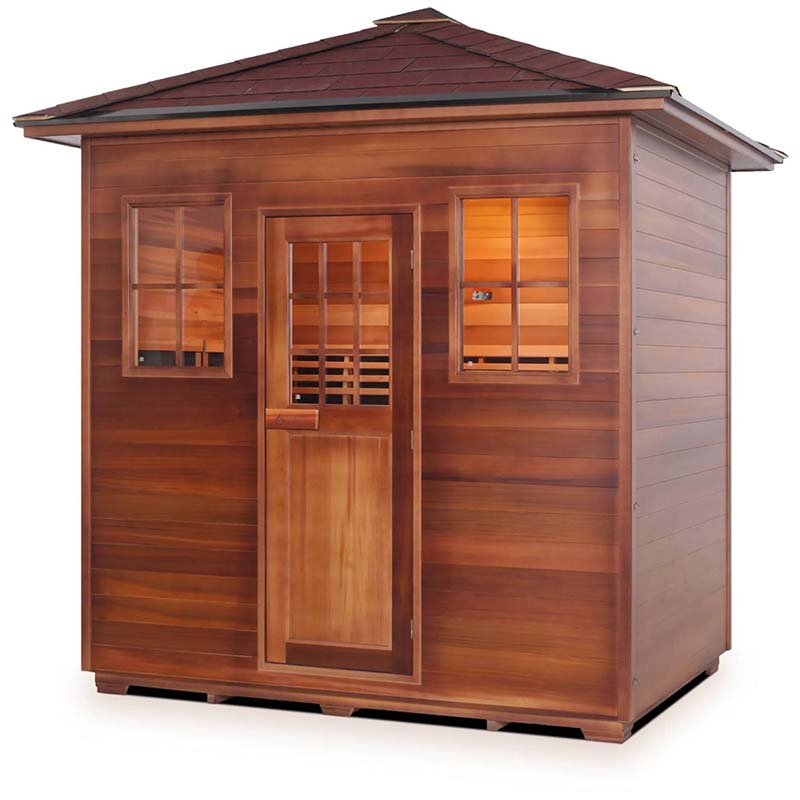 Outdoor wooden sauna with a shingled roof and two windows.