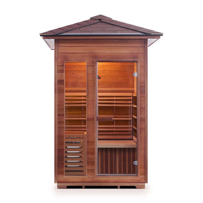 Outdoor cedar sauna with glass door and wooden benches.
