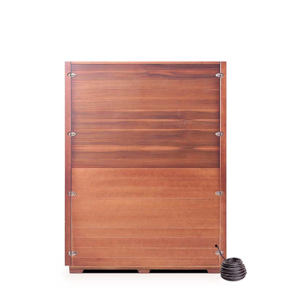 Wooden hot tub with copper finish and attached coil heater for outdoor relaxation.
