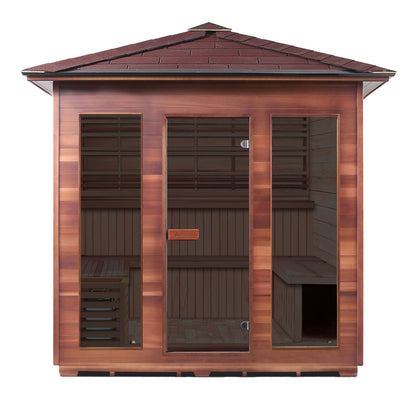 Outdoor cedar sauna with glass doors and a sloped roof for relaxation.