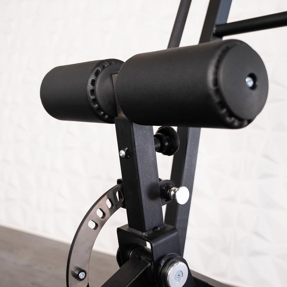 Back extension bench with dual padded rollers and metal frame.