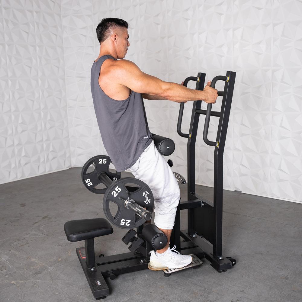 Man using a back extension machine with weight plates on a gym rack.