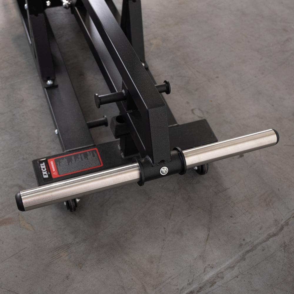 Standing hip thrust machine with bar and adjustable support frame.