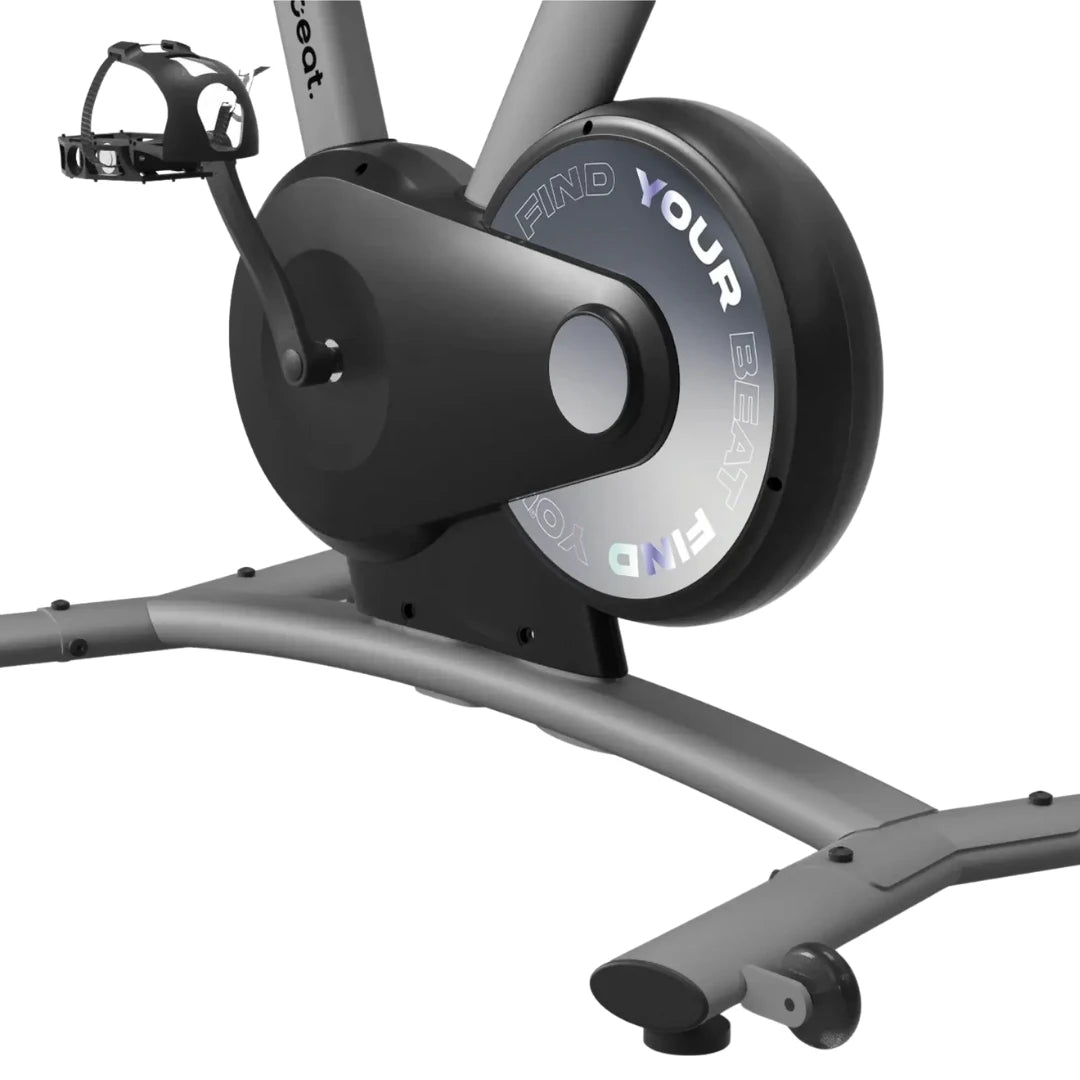 Close-up view of the Freebeat Boom Stationary Exercise Bike, highlighting the pedal and flywheel with the text 'FIND YOUR BEAT'.
