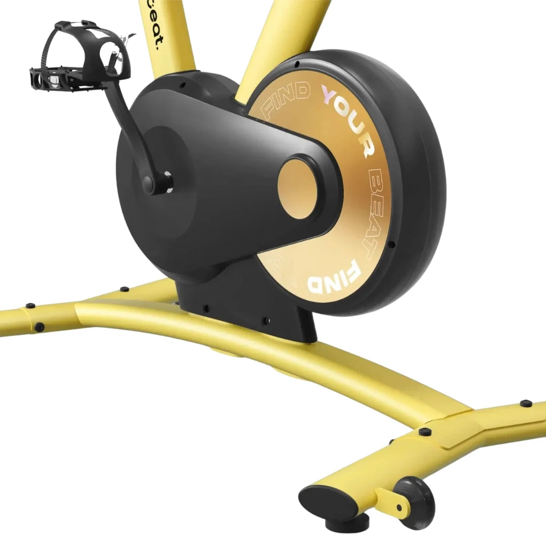 Close-up view of the Freebeat Boom Stationary Exercise Bike, highlighting the pedals and flywheel with the inscription FIND YOUR BEAT on the flywheel.