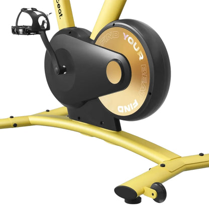 Close-up view of the Freebeat Boom Stationary Exercise Bike, highlighting the pedals and flywheel with the inscription FIND YOUR BEAT on the flywheel.