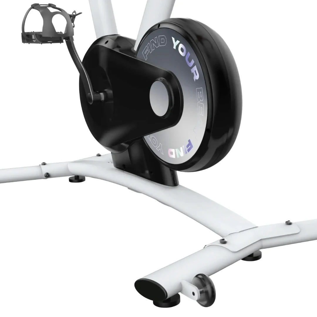 Close-up of the Freebeat Boom Stationary Exercise Bike showing the pedal mechanism and flywheel with the text FIND YOUR BEAT visible.