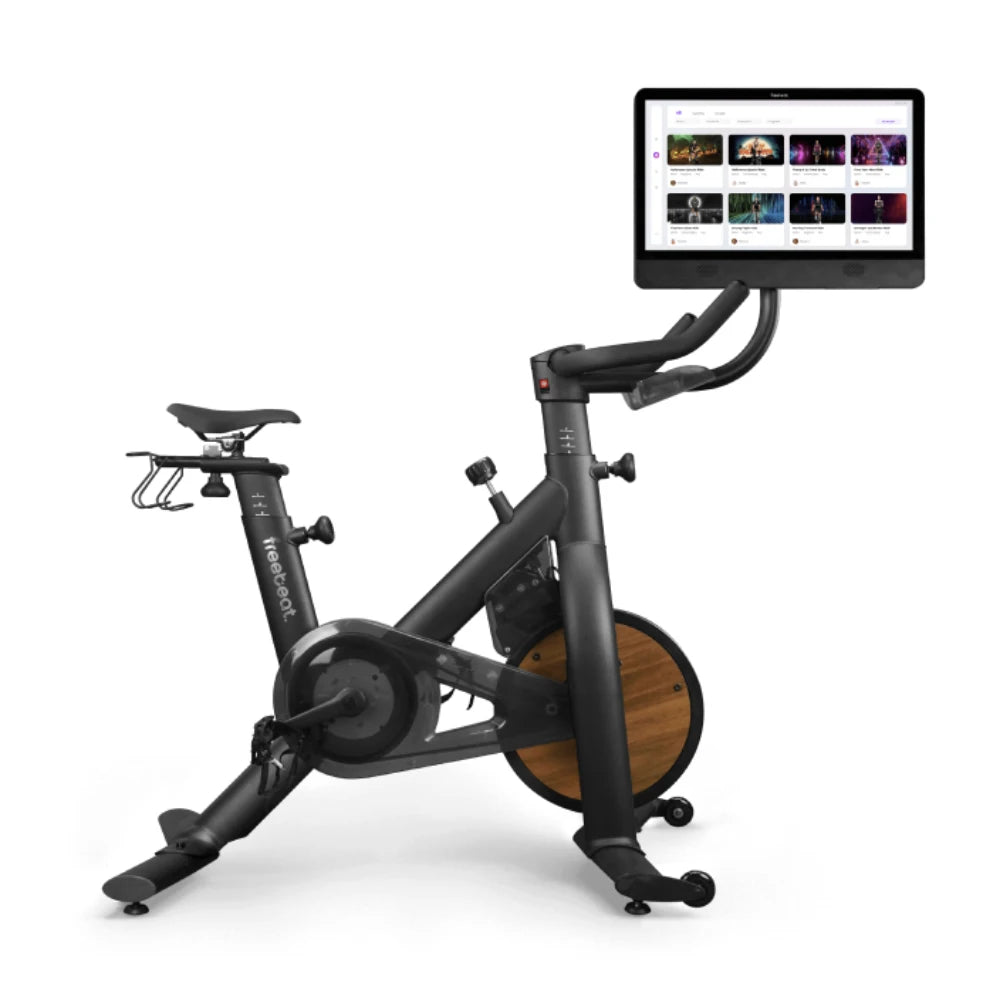 Tonal exercise bike with wood accents and interactive screen for home workouts.