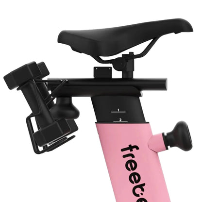 Close-up view of the Freebeat Lit Stationary Exercise Bike, showcasing the seat, adjustable settings, and attached dumbbells.