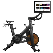 Freebeat Lit Stationary Exercise Bike with a sleek design and a large screen displaying workout classes.