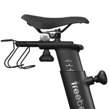 Close-up of the seat and handlebar area of the Freebeat Lit Stationary Exercise Bike, showcasing the seat adjustment mechanism and a water bottle holder.