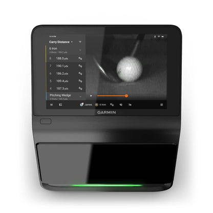 Garmin Approach R50 Premium Golf Launch Monitor & Simulator displaying data on carry distance and shot statistics, with a close-up view of a golf ball on the screen.