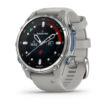 Garmin Descent Mk3 smartwatch with a round face, featuring a black display and silver bezel, showcasing time and dive information, set against a light gray silicone strap.