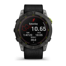 Garmin Enduro 2 smartwatch displaying running statistics including distance, time, pace, and weekly summary on a black background with a textured strap.