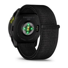 Back view of the Garmin Enduro 3 smartwatch featuring a black woven strap, heart rate sensors, and solar charging capability.