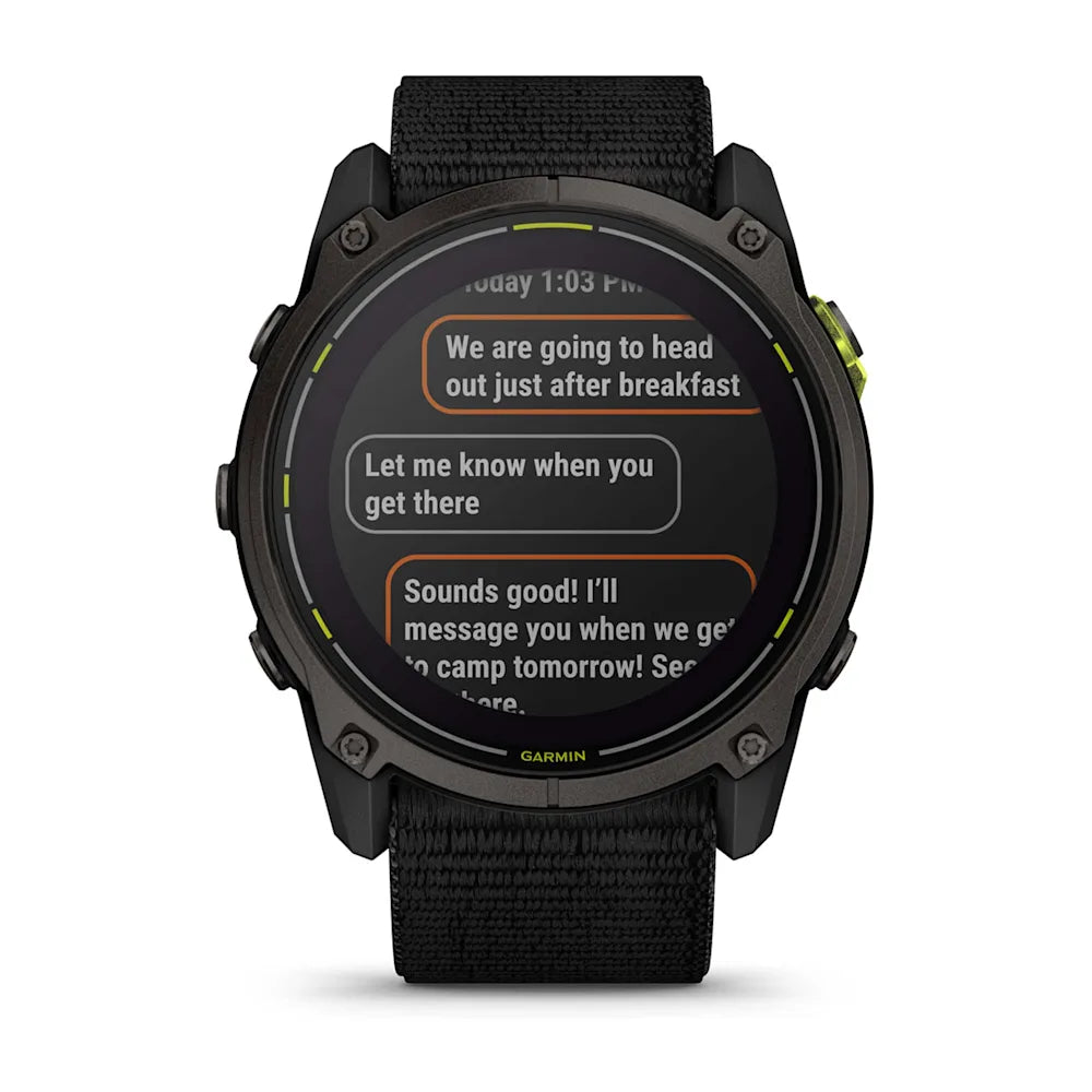 Close-up of a Garmin Enduro 3 smartwatch displaying text messages with a black strap and digital screen.