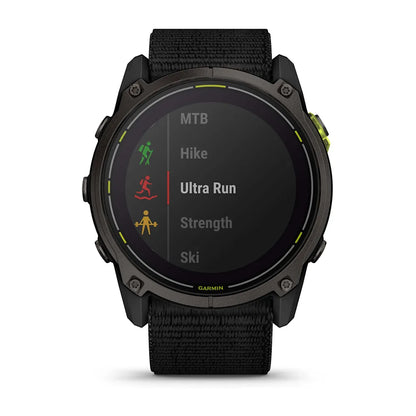 Garmin Enduro 3 smartwatch displaying activity options including MTB, Hike, Ultra Run, Strength, and Ski on a digital screen.