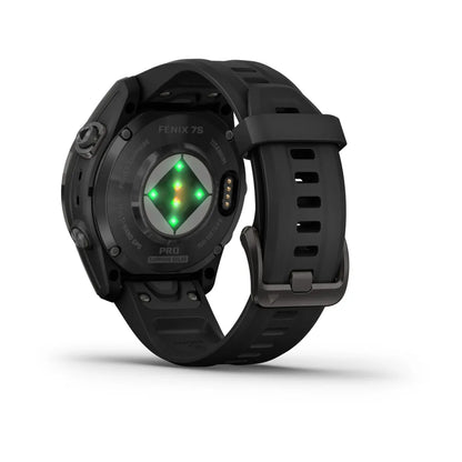 Garmin Fenix 7S Pro Sapphire Solar Edition smartwatch showing the back view with a black strap and green sensors illuminated.
