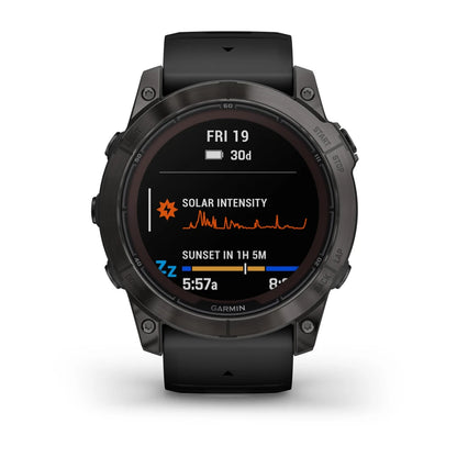 Garmin Fenix 7X Pro Sapphire Solar Edition smartwatch displaying solar intensity and sunset time information on its screen.