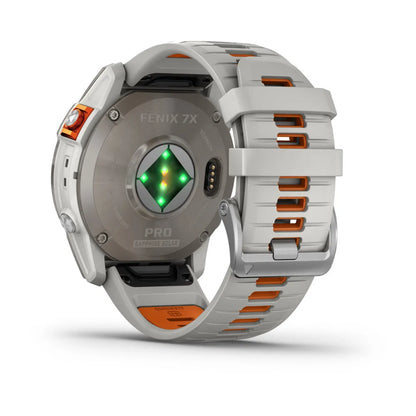 Back view of the Garmin Fenix 7X Pro Sapphire Solar Edition smartwatch, showcasing the sensor and white strap with orange accents.