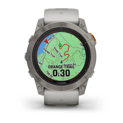 Garmin Fenix 7X Pro Sapphire Solar Edition smartwatch displaying a map with highlighted trails and navigation indicators.