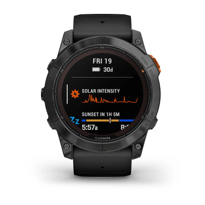 Garmin Fenix 7X Pro Solar Edition smartwatch displaying solar intensity and sunset time on the screen.