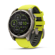 Garmin Fenix 8 Sapphire Solar Edition smartwatch with a vibrant yellow strap, displaying various fitness metrics on a digital screen.