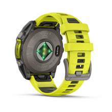 Garmin Fenix 8 Sapphire Solar Edition smartwatch featuring a vibrant yellow strap, displaying the back view with sensors and charging contacts.