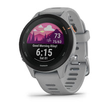 Garmin Forerunner 255S smartwatch displaying a morning greeting, weather information, and time on a colorful screen.